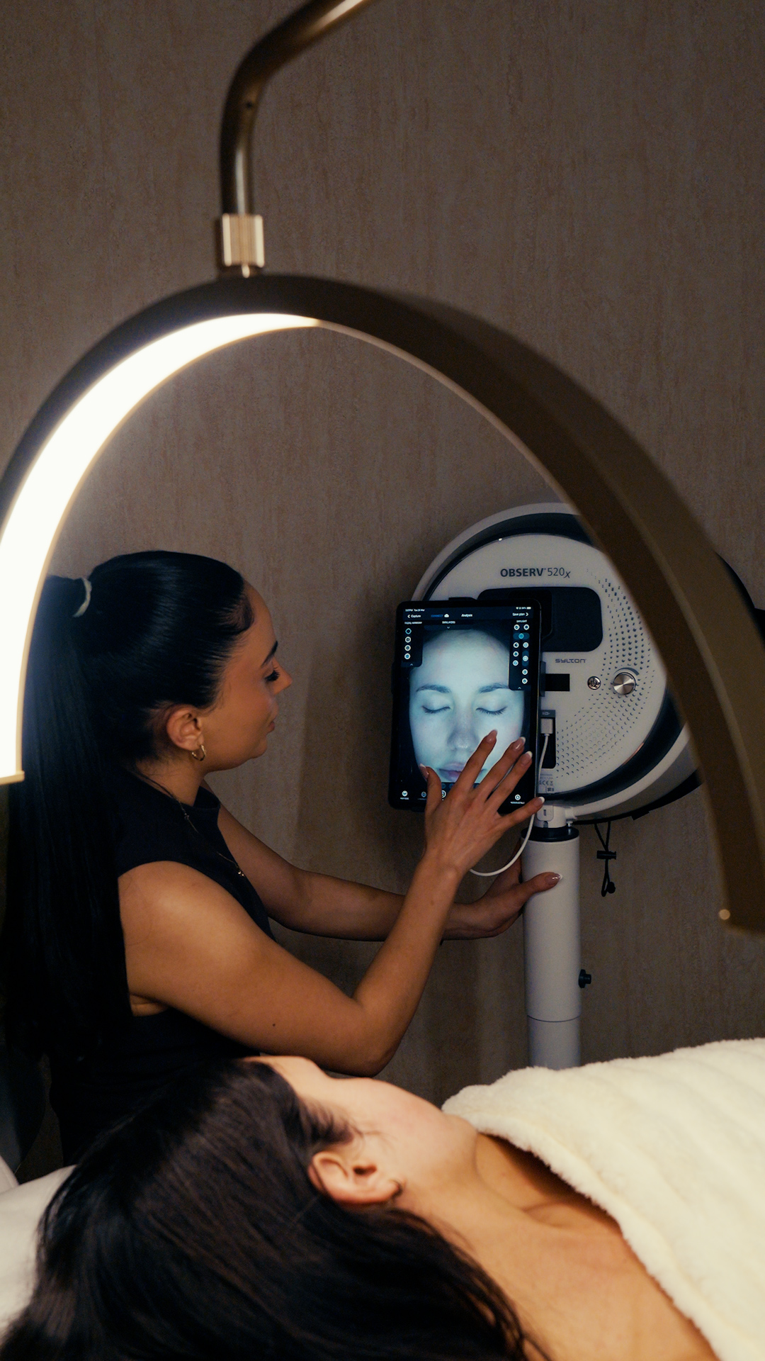 A Saint Serene clinician reviewing a professional skin analysis